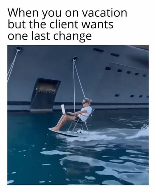 man on vacation working on laptop while sitting on a swing over water with a cruise ship in the background