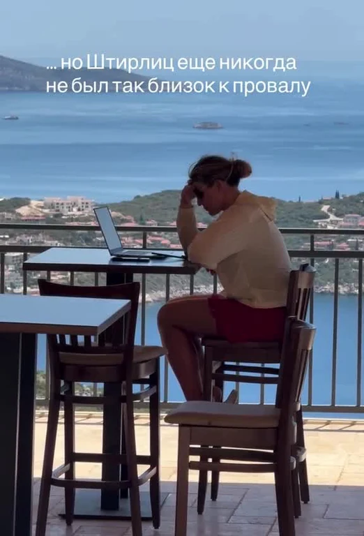 woman sitting on a chair with a laptop on a scenic outdoor patio
