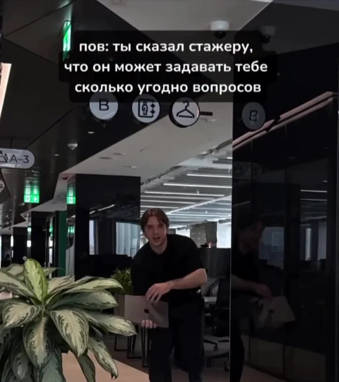 Man in office setting with laptop and shocked expression
