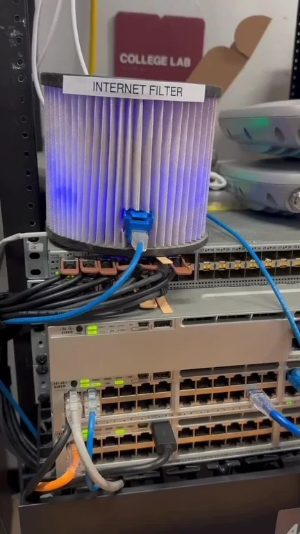 A server rack with a physical air filter labeled Internet Filter connected by ethernet cables