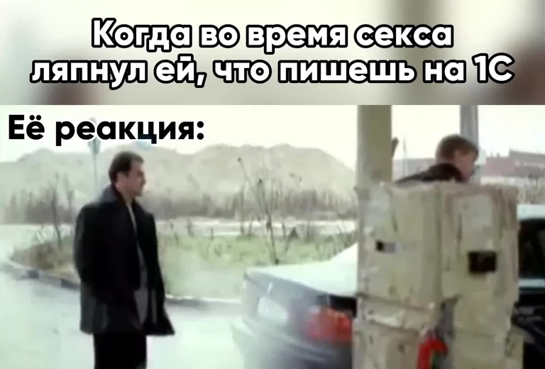 Man standing outside while another hides behind boxes with a shocked expression