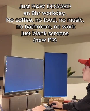 Programmer working on dual monitors with blank screens