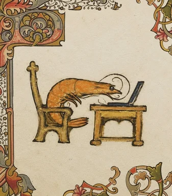 A shrimp sitting at a desk with a laptop