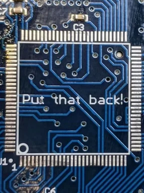 Circuit board with the text 'Put that back!'