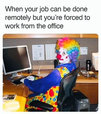 clown sitting at office desk with computer