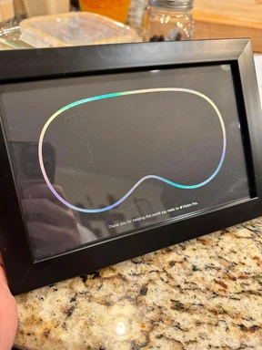 Apple gift for Vision Pro team: a framed empty VR headset outline