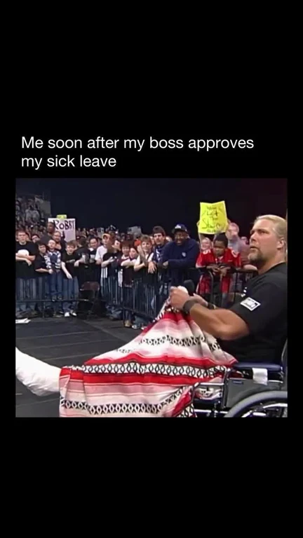 Man in wheelchair celebrating with a blanket, surrounded by a crowd