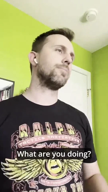 man in black t-shirt looking confused with text 'What are you doing?'