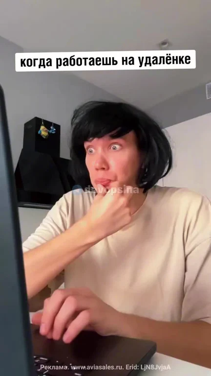 person sitting at computer with surprised expression
