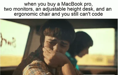 humorous image of a person covering their face with their hand, sitting in a car with another person in the background, relating to coding struggles