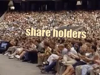 A crowded auditorium full of people labeled as share holders