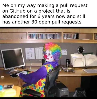 clown sitting at office desk with computer