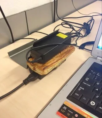 a laptop power adapter on top of toast in a toaster