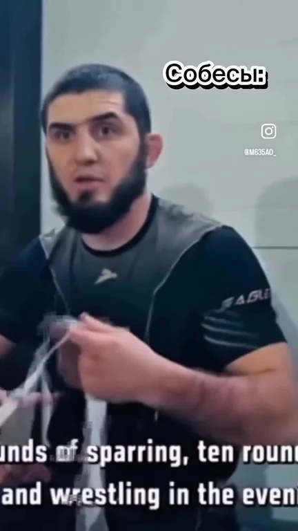 man in black shirt and sports vest looking surprised or skeptical