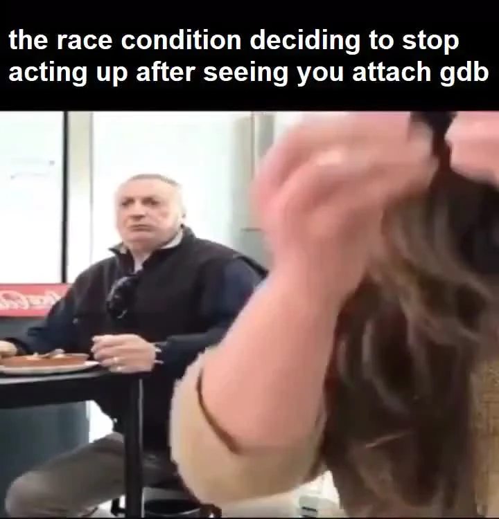 a man sitting at a table looking relieved as a woman reacts in the foreground, with text about a race condition