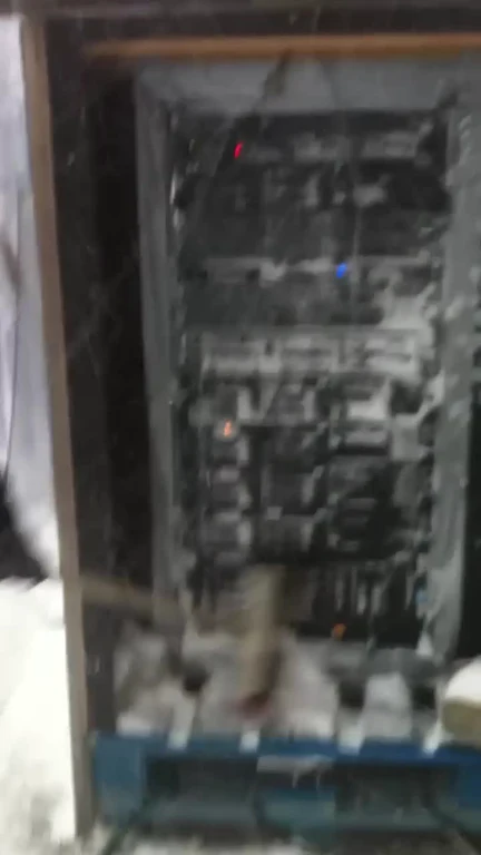 A server rack with blinking lights buried deep in snow
