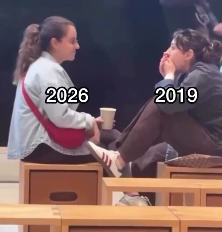 Two women sitting on wooden stools, one labeled 2026 and the other 2019