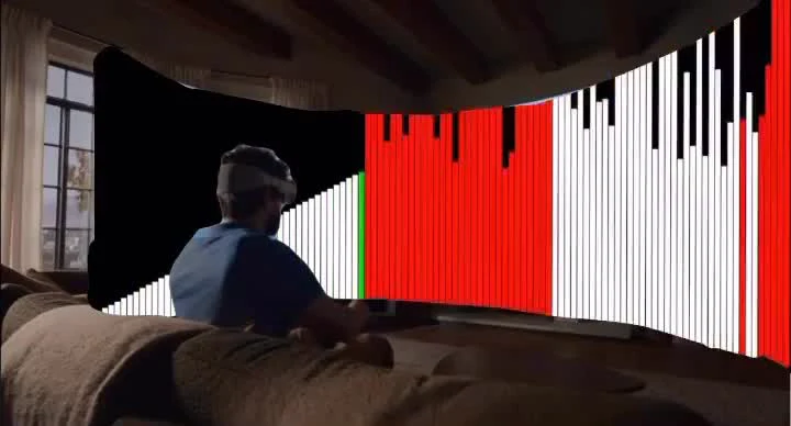 Man wearing VR headset sitting on couch looking at large screen with glitch art of a flag