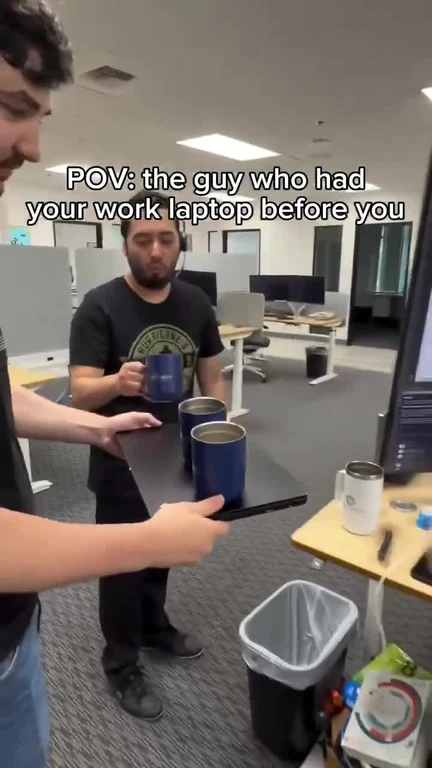 Two men in an office setting with a caption about a previous laptop user