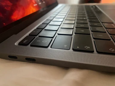 Close-up of a laptop keyboard with a red screen