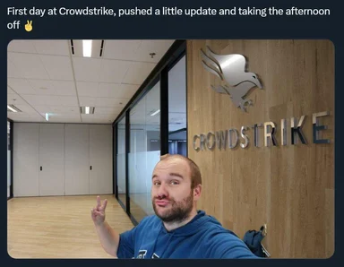 Man in blue hoodie making a peace sign in front of Crowdstrike office