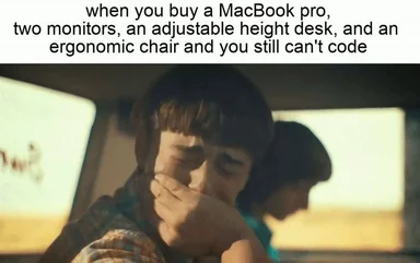 humorous meme of a frustrated developer with a MacBook and ergonomic setup