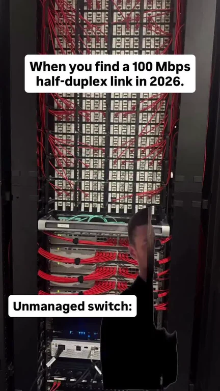 server room meme with a man looking surprised in front of a network switch