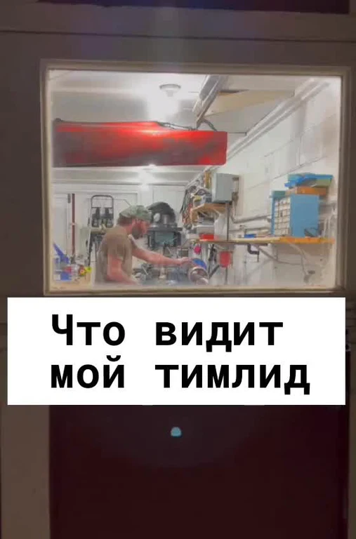 a man working on a machine in a workshop with a text overlay