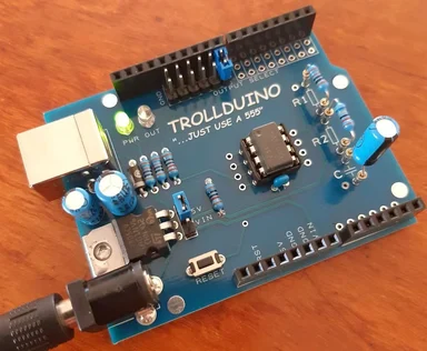 Trollduino circuit board with the text 'TROLLDUINO ...JUST USE A 555'