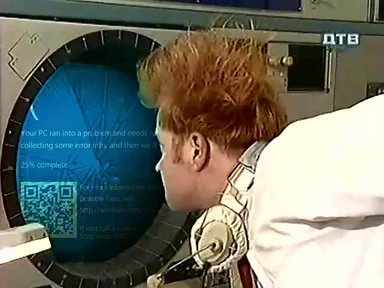 Astronaut looking at a computer screen displaying a Windows Blue Screen of Death