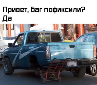 a blue pickup truck with a missing wheel and a dolly under it
