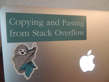 Sticker on a laptop reading 'Copying and Pasting from Stack Overflow'