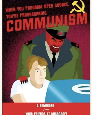 cartoon of a red devil in a soviet military uniform standing behind a man sitting at a computer with a Windows logo on the monitor