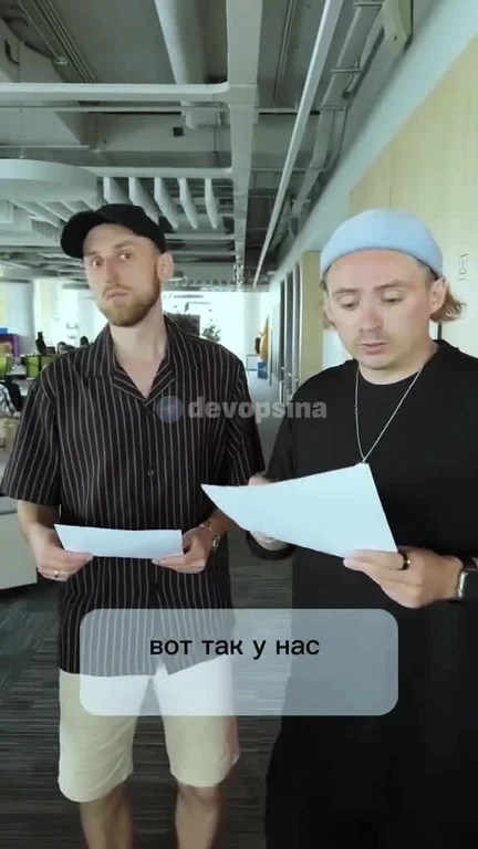 Two men in an office setting looking at papers