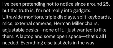 Text meme on black background confessing lack of interest in tech gadgets like ultrawide monitors and Herman Miller chairs