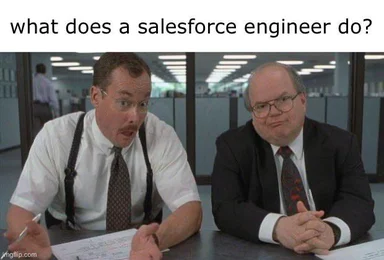 Two men sitting at a desk looking confused