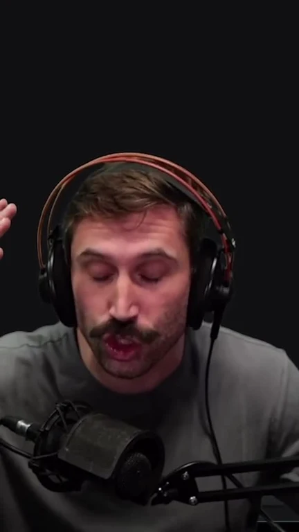 Man wearing headphones speaking into a microphone