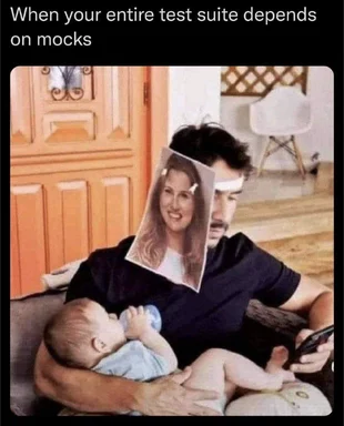 man holding baby with woman's face on his face