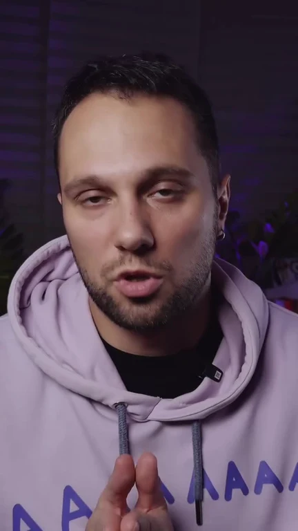 man in light purple hoodie looking surprised or concerned