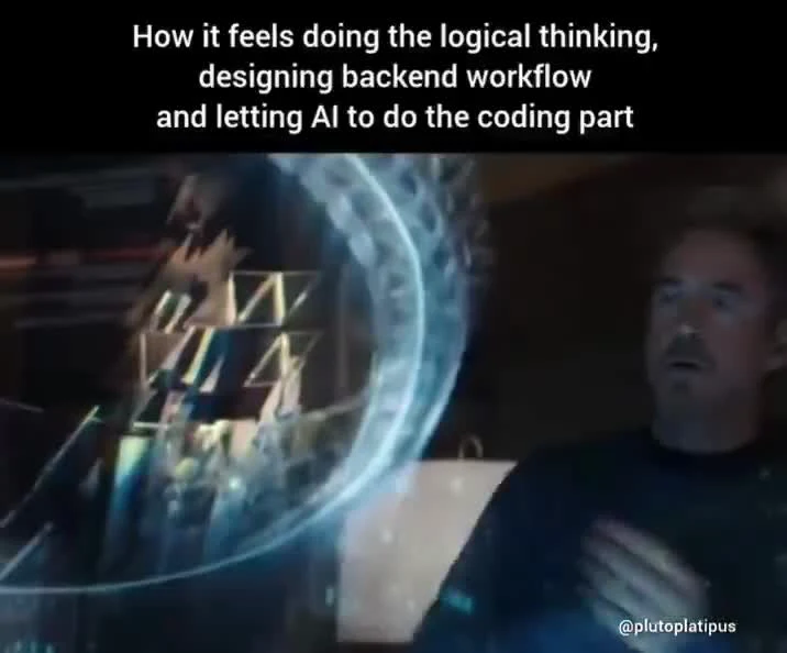 Tony Stark looking at a holographic interface with text about letting AI do the coding part