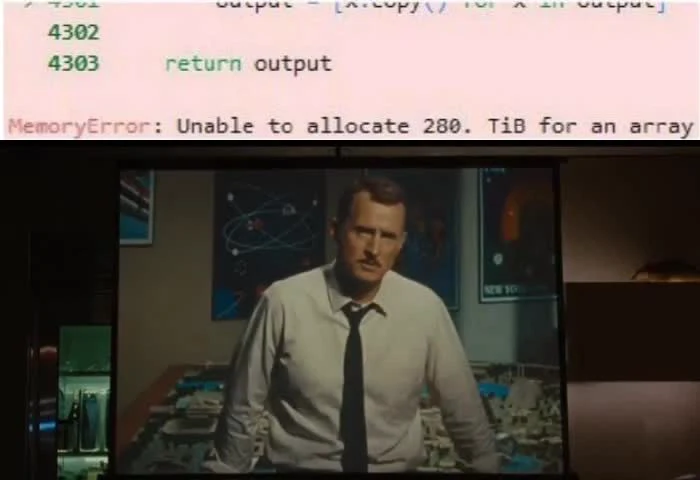 Man in a white shirt and black tie on a computer screen with a MemoryError message