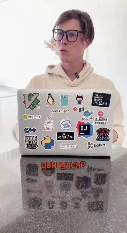 programmer with laptop stickers