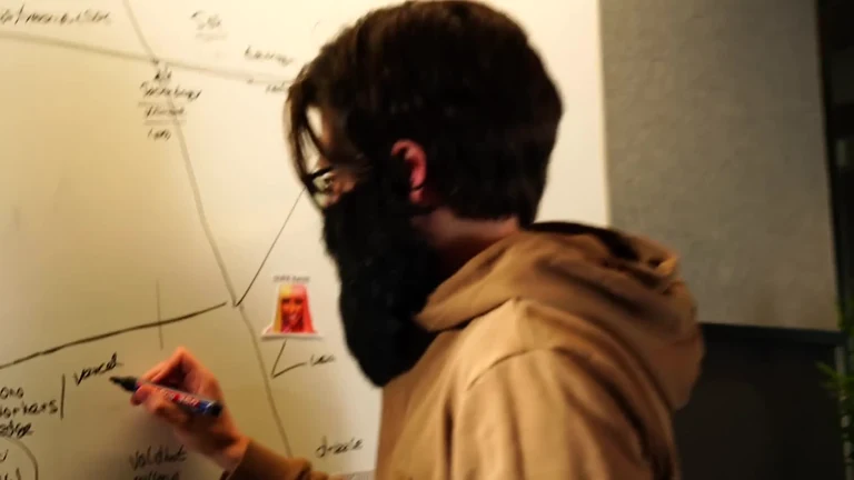 Man writing on a whiteboard with a marker