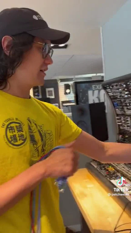 A young man in a yellow shirt and black cap reacts to a Kubernetes deployment