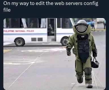 Person in bomb disposal suit walking towards a bus