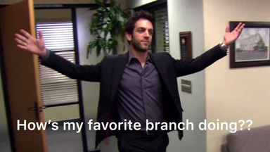 Man in office with arms outstretched and text 'How's my favorite branch doing??'