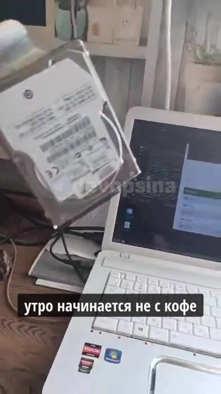 Hard drive on a stand next to a laptop with a humorous caption