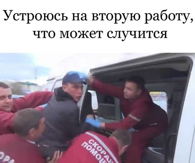 men in red uniforms putting a man in an ambulance