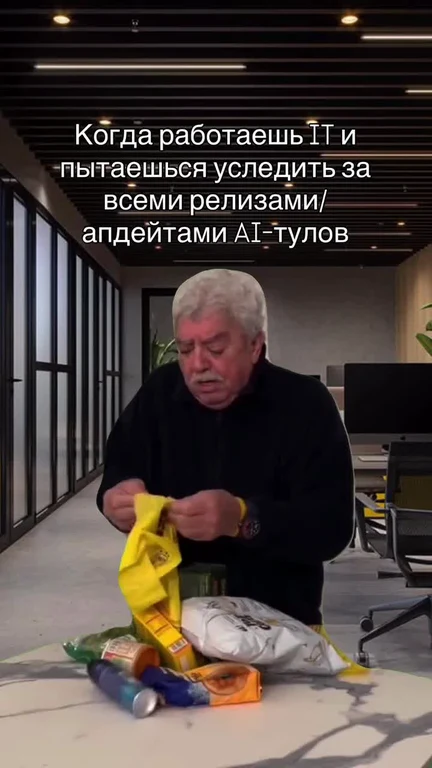 Man in black shirt struggling with groceries in office