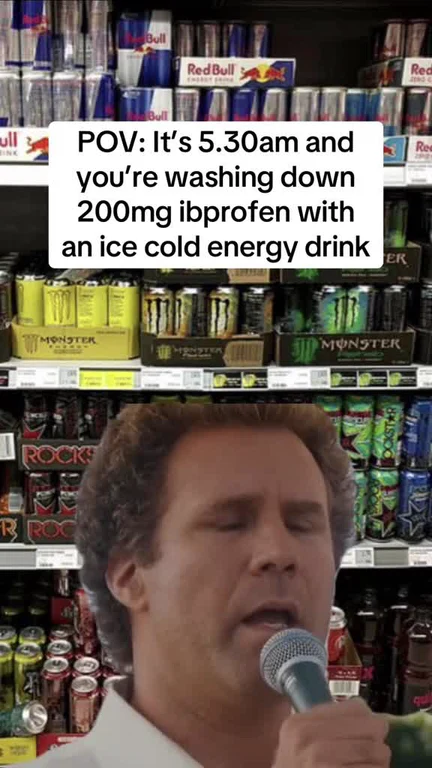 Man singing into a microphone in front of shelves of Red Bull and Monster energy drinks with text overlay about taking ibuprofen at 5:30 am.